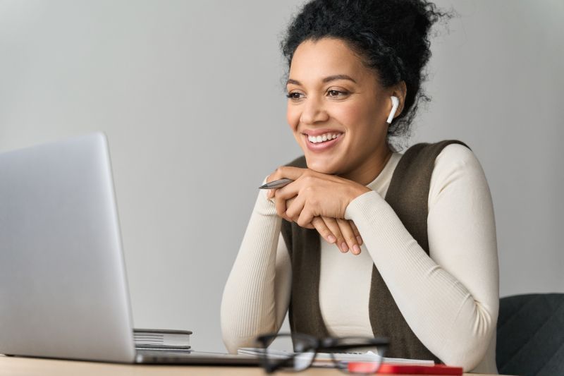 Photo of Interpreter using laptop computer and earbuds